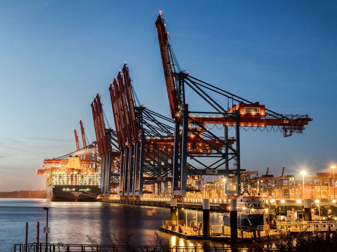 Container port with cranes at dusk