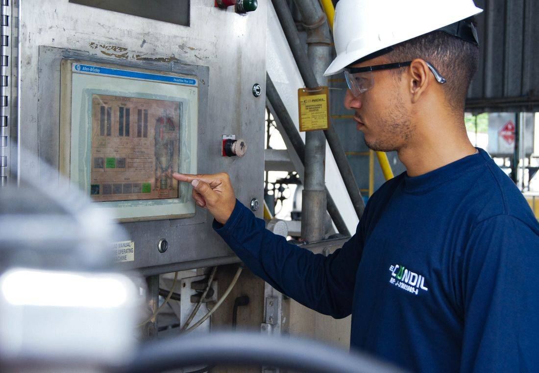 Marine engineer operating an engine control panel